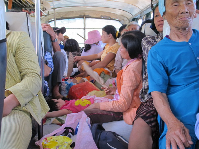 Inside the bus, some passengers even sat on the goods packed on the aisle.
