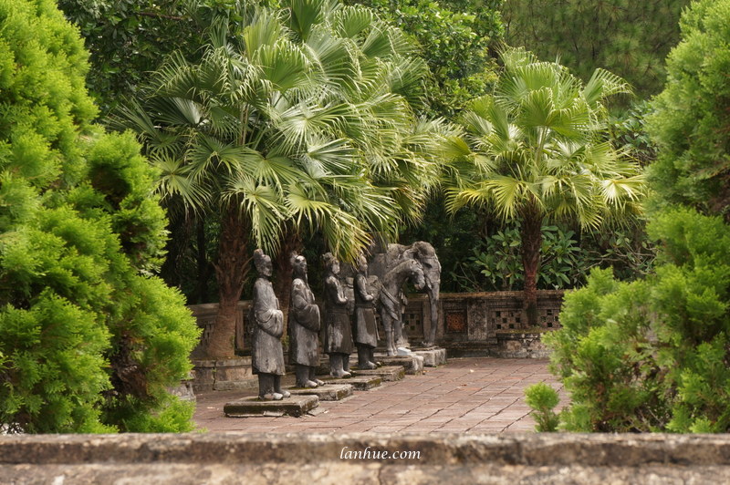 One of the two rows of cement sculptures of mandarins, horses and elephants at Tư Lăng