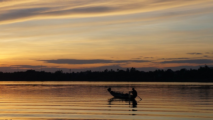 A fisherman working at dawn