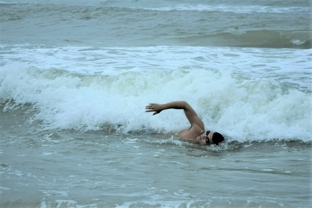 a swimmer in white waves