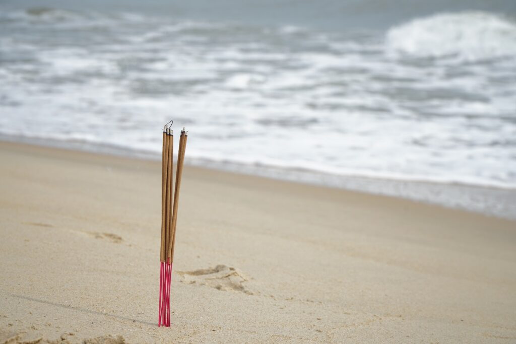 Incense sticks burnt on the shore
