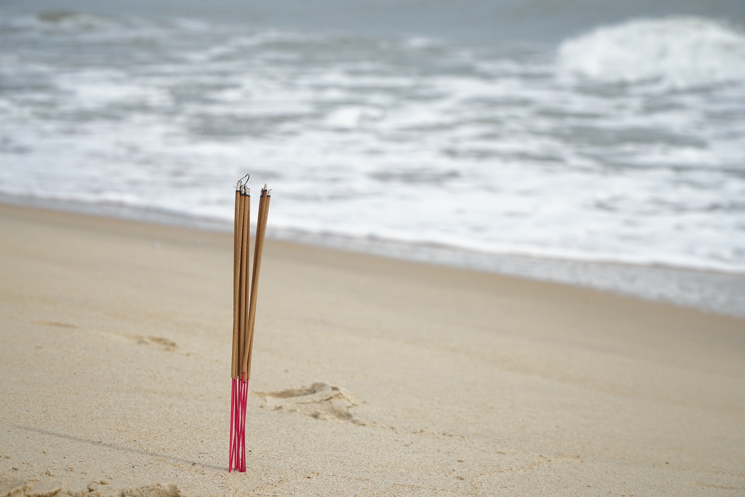 Incense sticks burnt on the shore